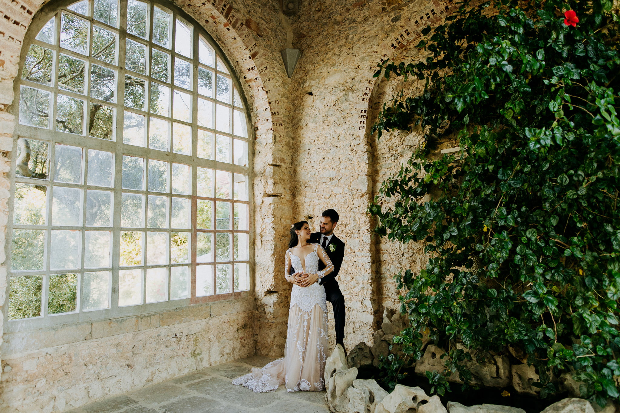 Forte da Cruz wedding exterior portrait session couple wide shot with leaves inside
